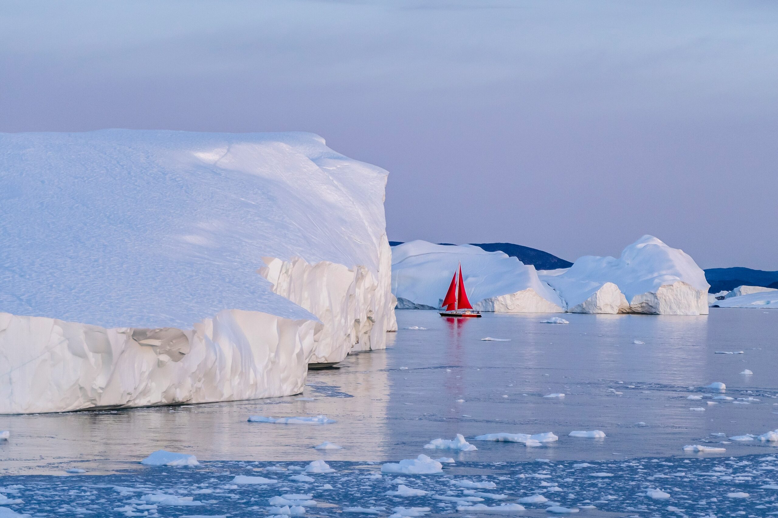 A boat next to icebergs