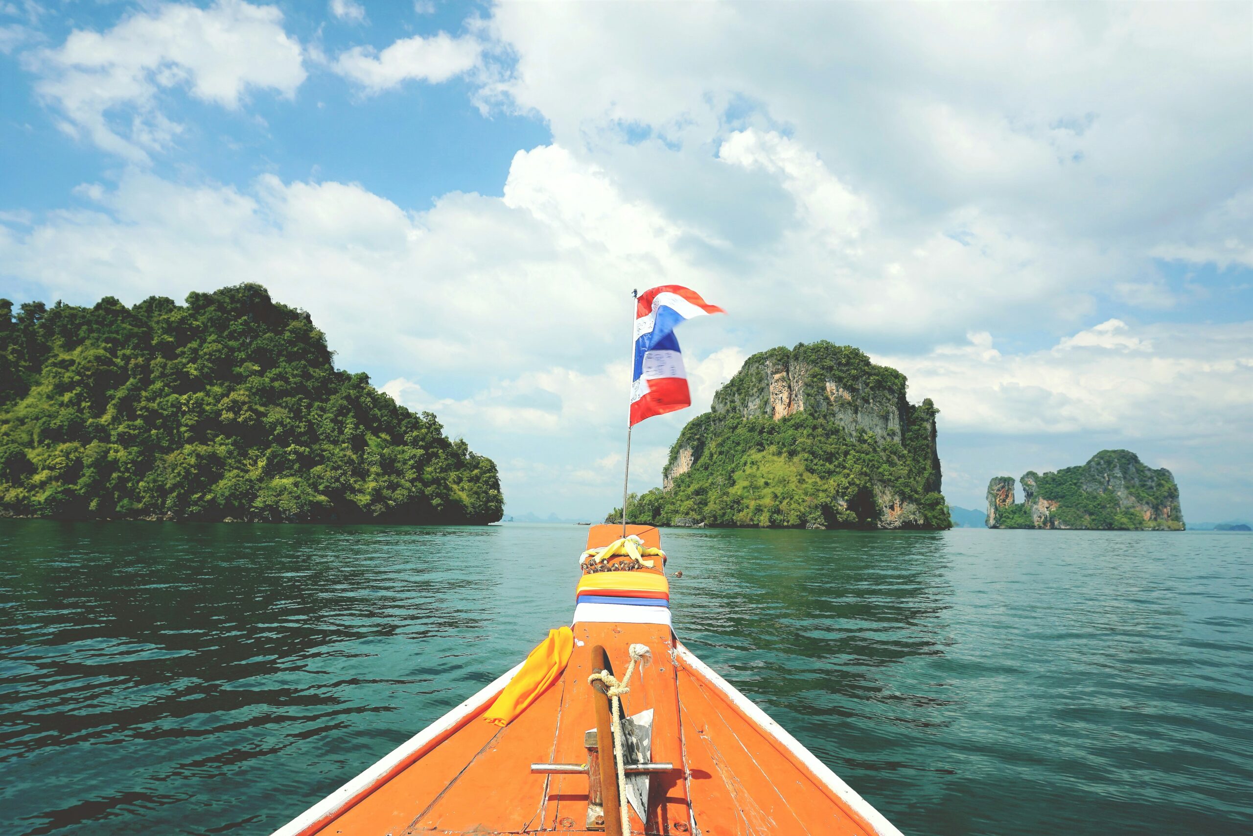 wooden boat between two islands
