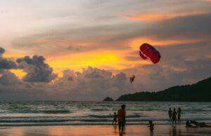 Exploring the Beaches of Phuket paragliding over a sandy beach
