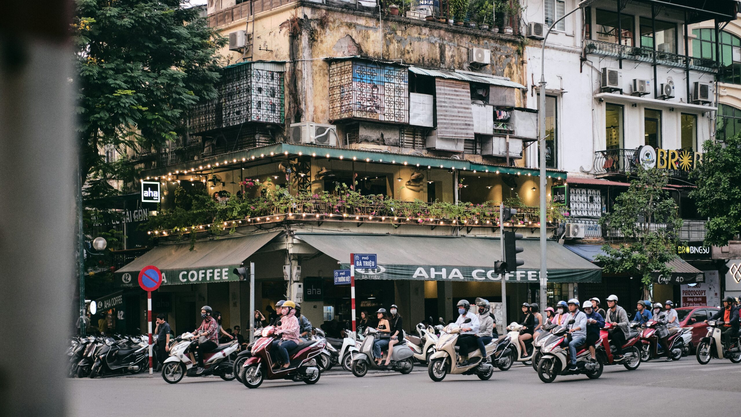 motorbikes driving by a coffee shop