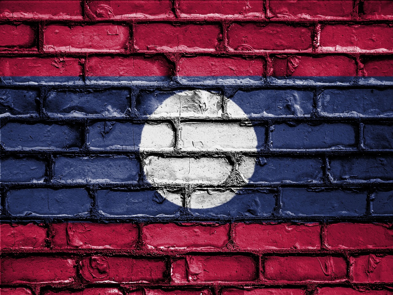 a brick wall in red blue and a white circle