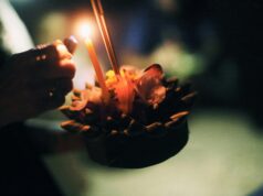 Celebrating Loy Krathong in November: Thailand’s Festival of Lights a candle being lit