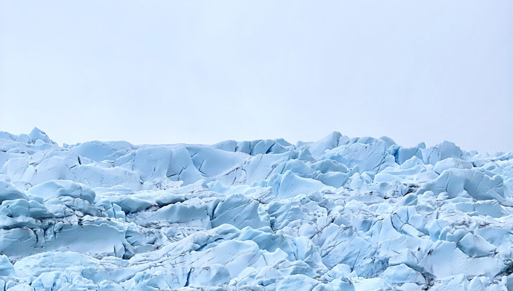 boat in front of icebergs