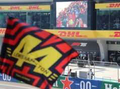 How Much Would It Cost to Attend Every Formula 1 Race? flags at race track