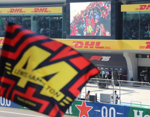 How Much Would It Cost to Attend Every Formula 1 Race? flags at race track