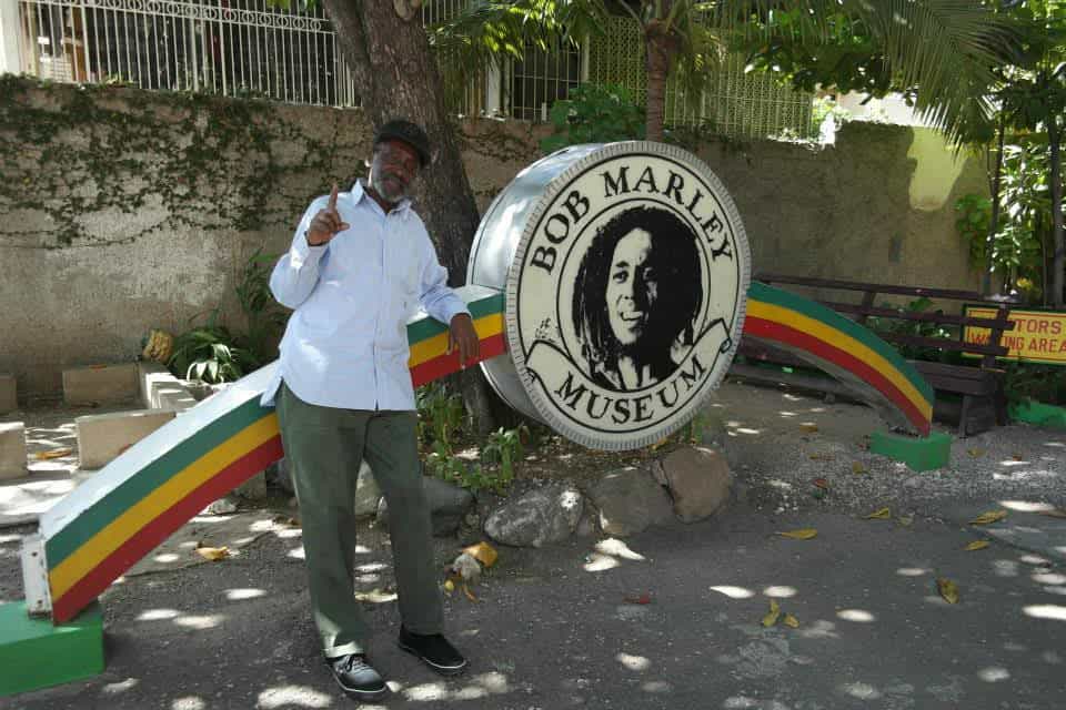 a guy standing infront of a big sign