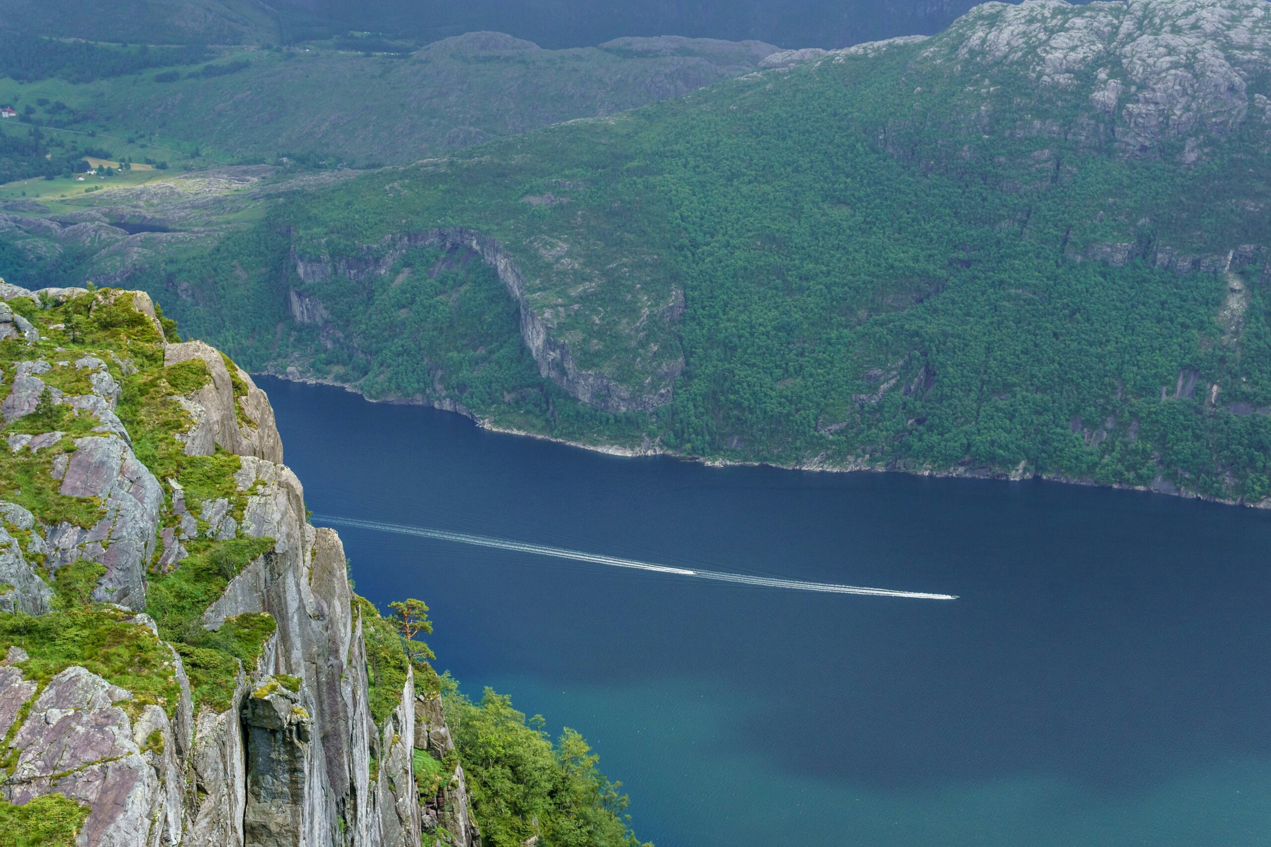 a boat cruising a fjord 