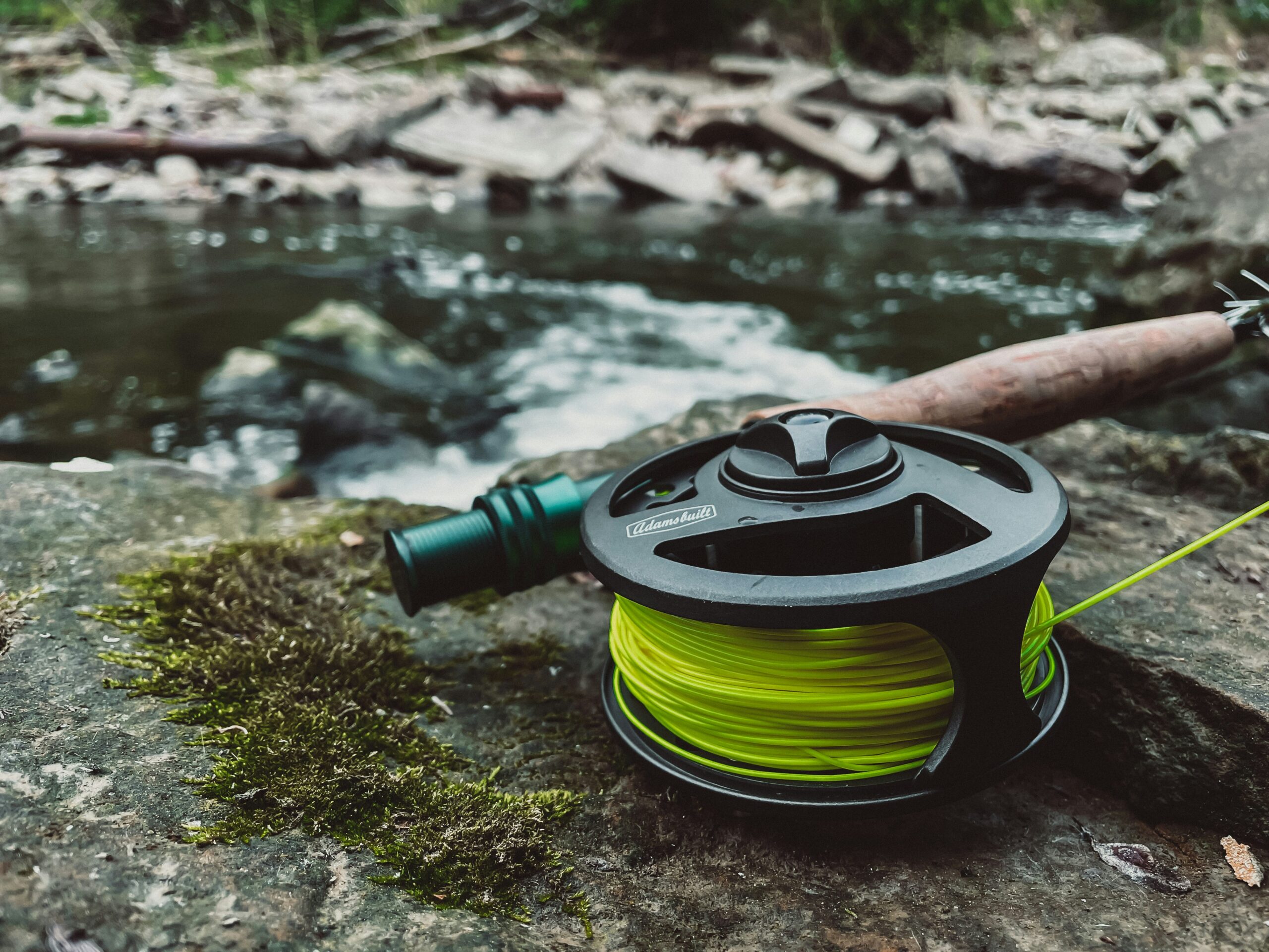 a fishing rod on the rocks