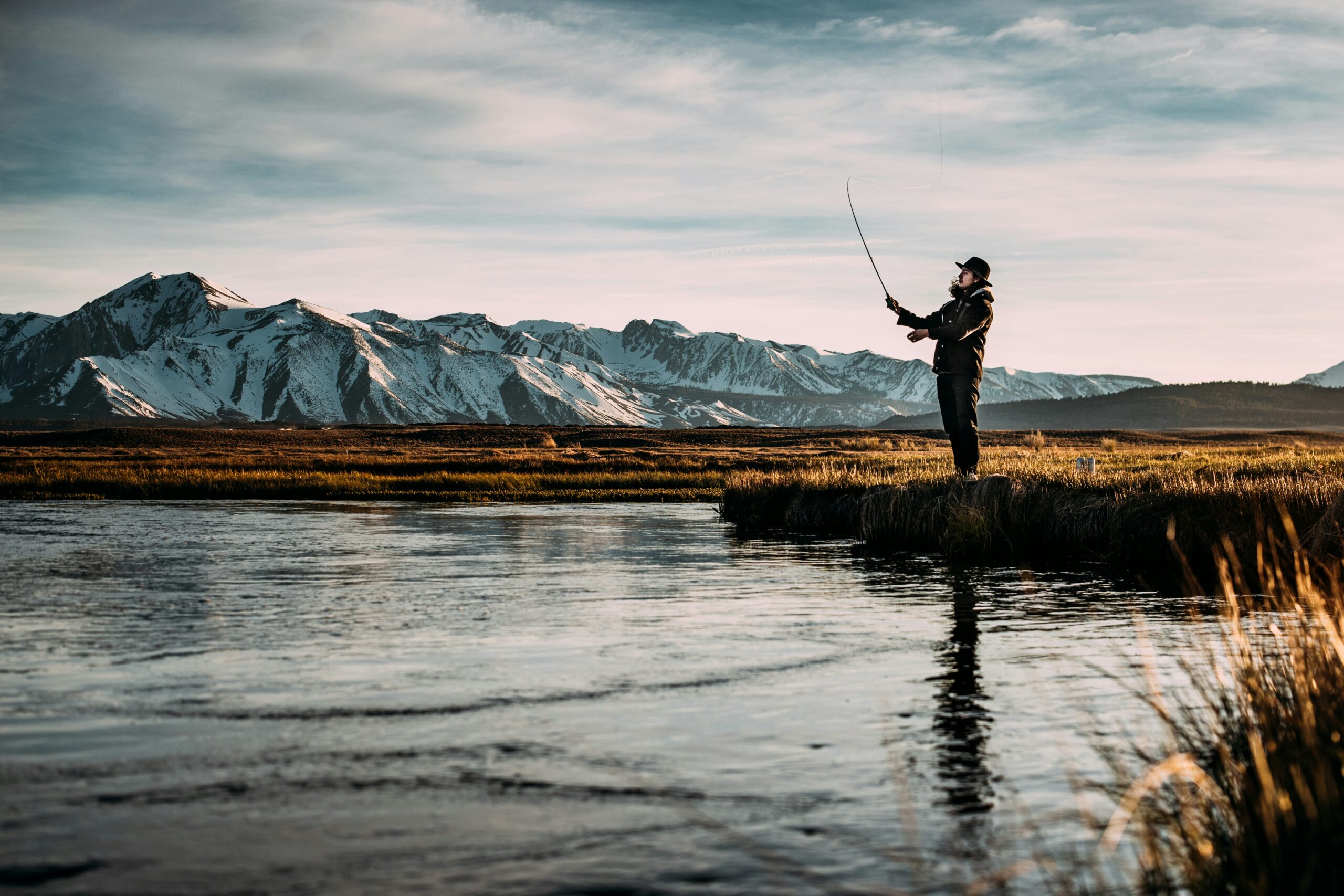 a guy fishing in a river