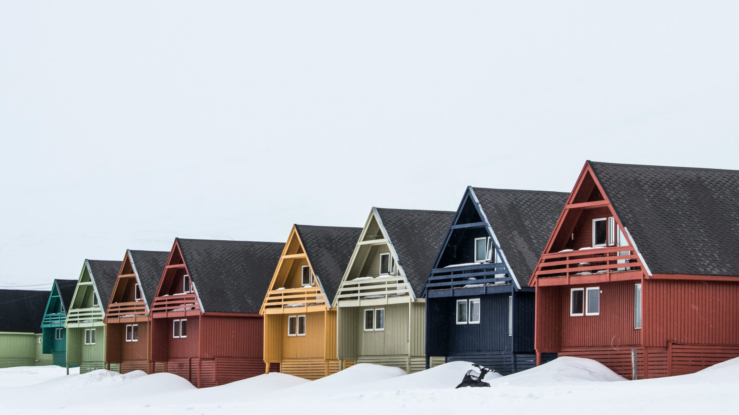 different colour houses in the snow