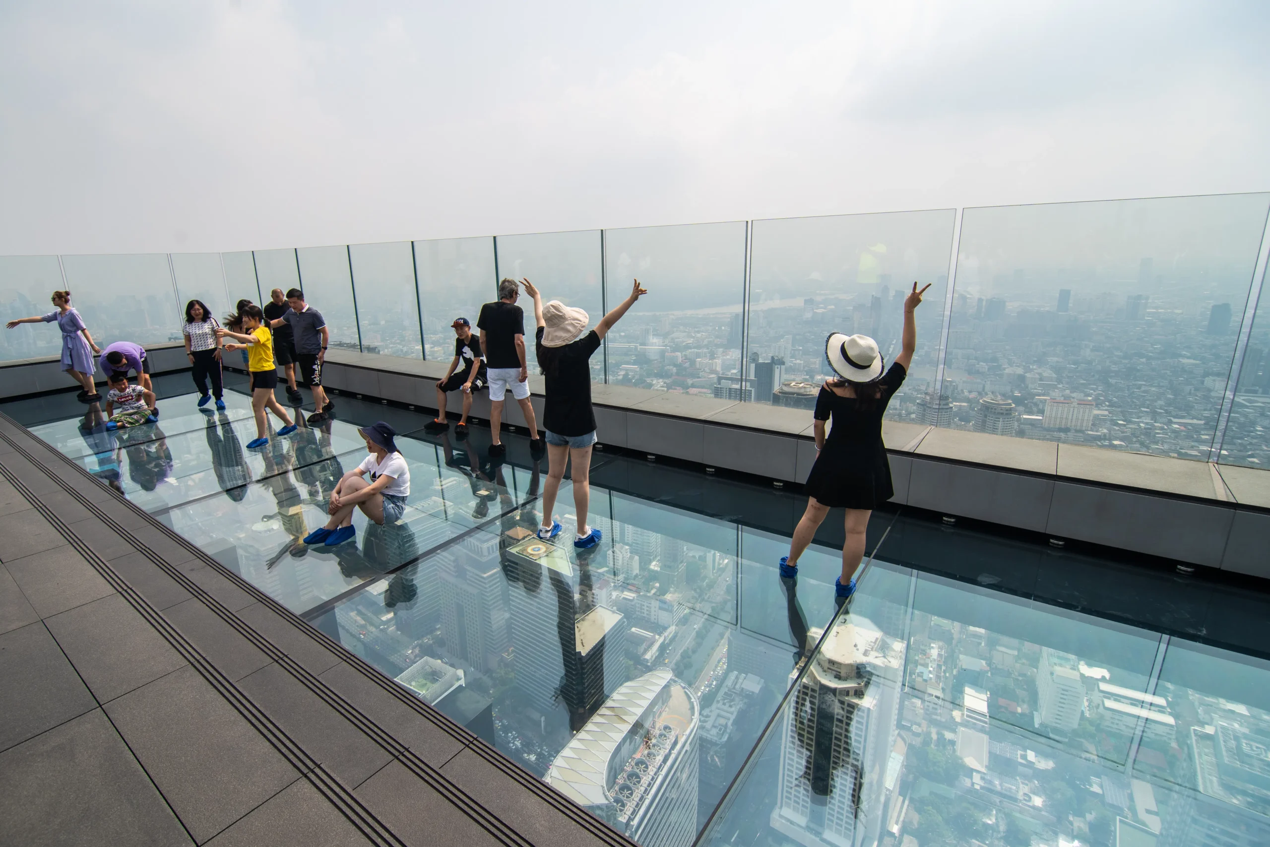 a group of people standing on a glass floor