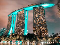 The Complete Singapore River Walk: From Robertson Quay to the Iconic Merlion a big hotel in green neon lights