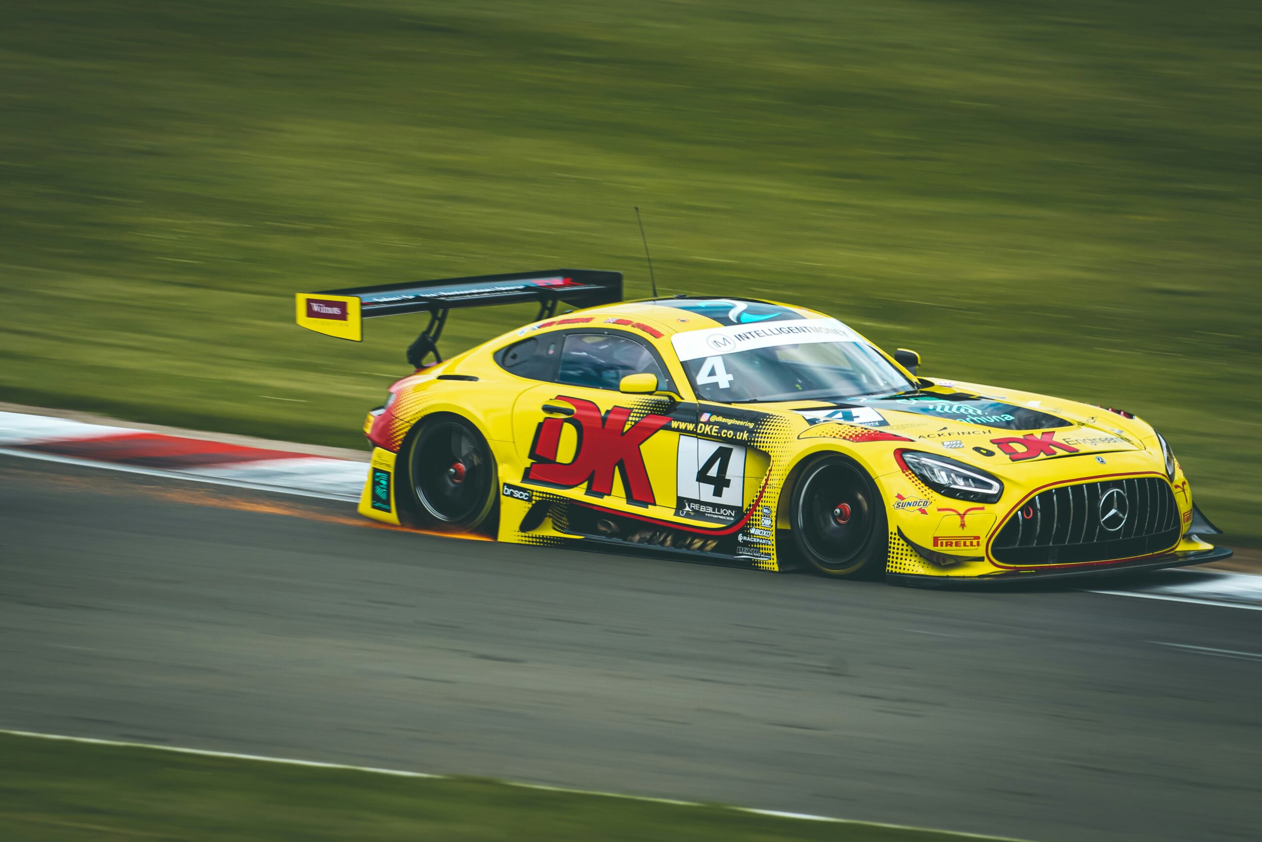 a yellow racing car with lots of stickers