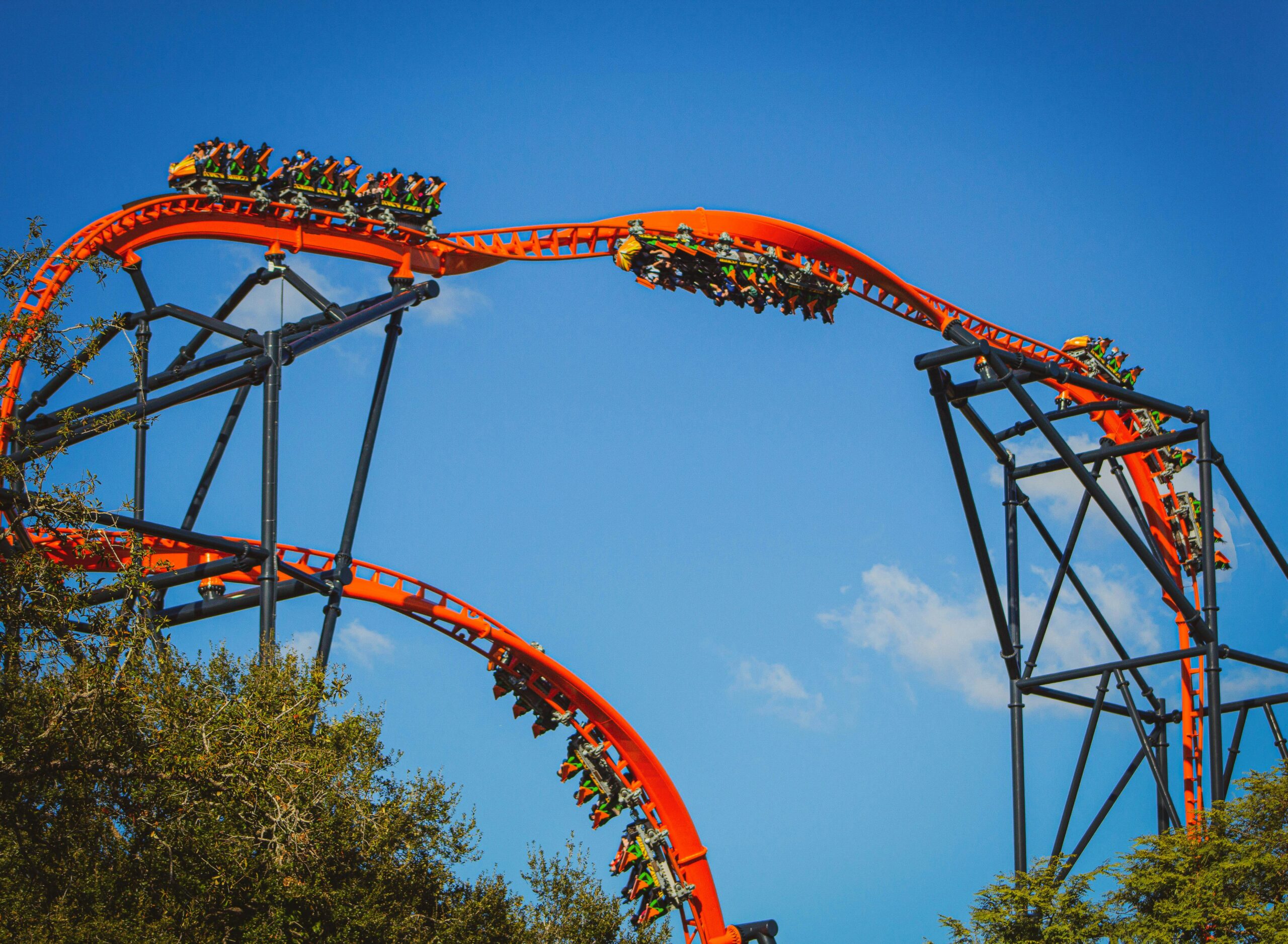 people hanging upside down in a roller coaster
