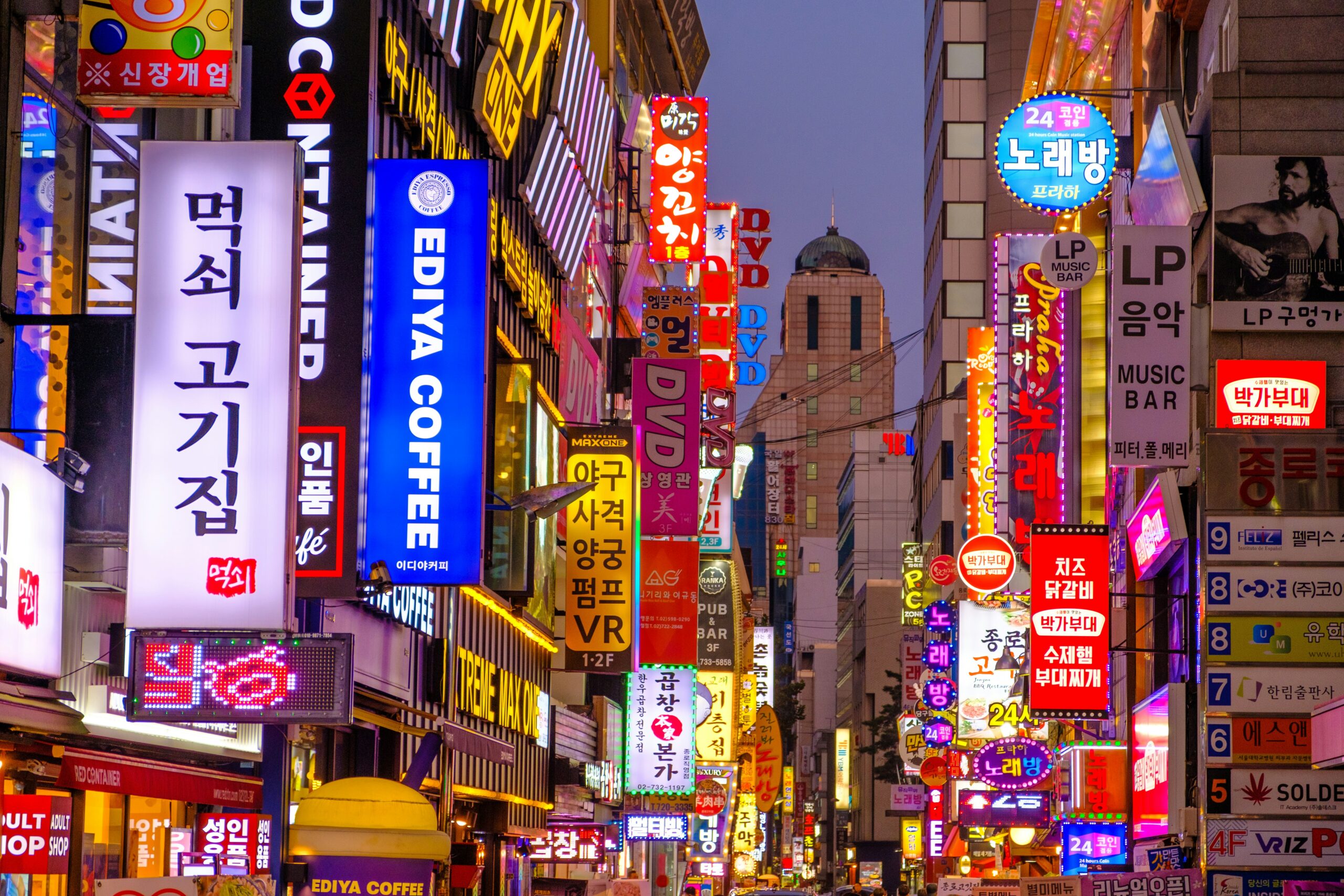 lots of neon signs on buildings