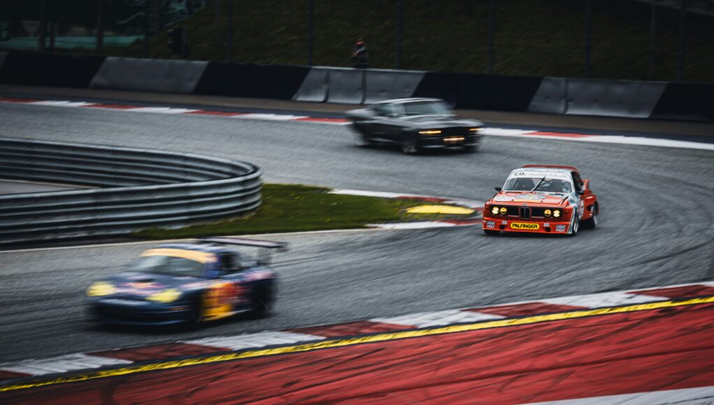 three race cars on a racing track