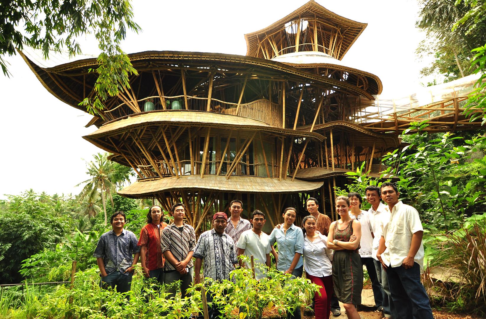 A big treehouse surrounded by a group of people