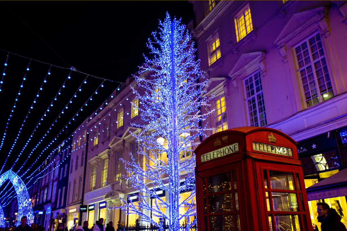 a uk red phone booth and a christmas tree