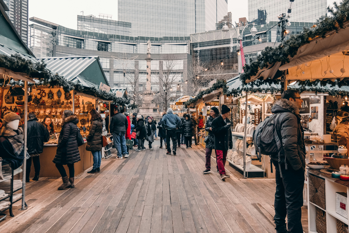 people christmas shopping at an outdoor market