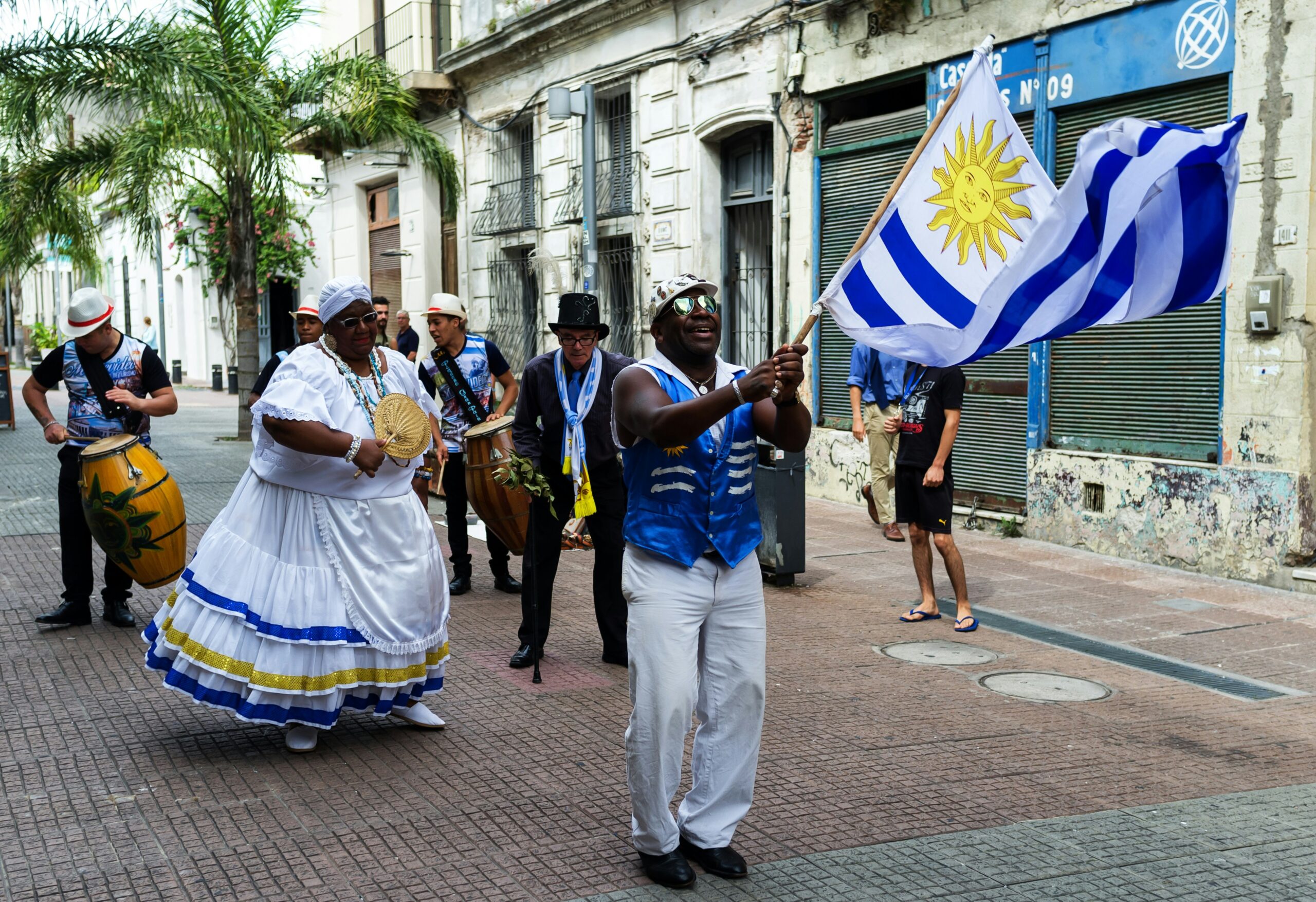 a man holding a flag in the street